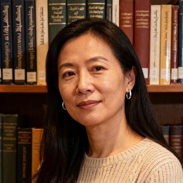 跨文化沟通专家王思涵博士的头像，一位三十五岁左右的学者型女性，长发披肩，佩戴简约的银色耳环，身穿米色针织衫，背景书架上有多种语言的原版书籍，气质知性优雅。